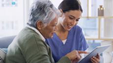 Healthcare worker showing tablet to patient